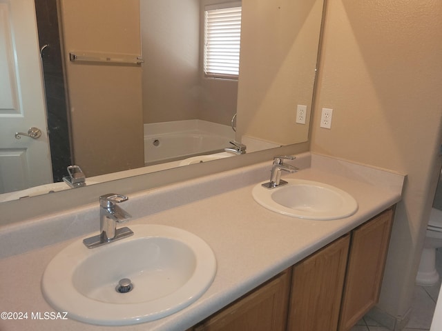 bathroom with a bathing tub, vanity, and toilet