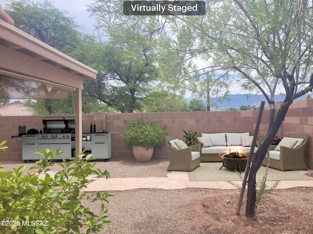 view of patio / terrace with an outdoor kitchen, a fire pit, and grilling area