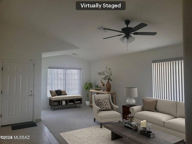 carpeted living room featuring ceiling fan and lofted ceiling