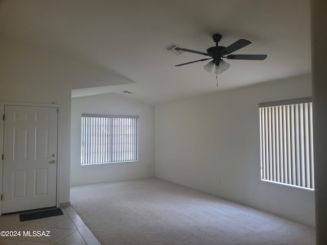 carpeted empty room with lofted ceiling and ceiling fan