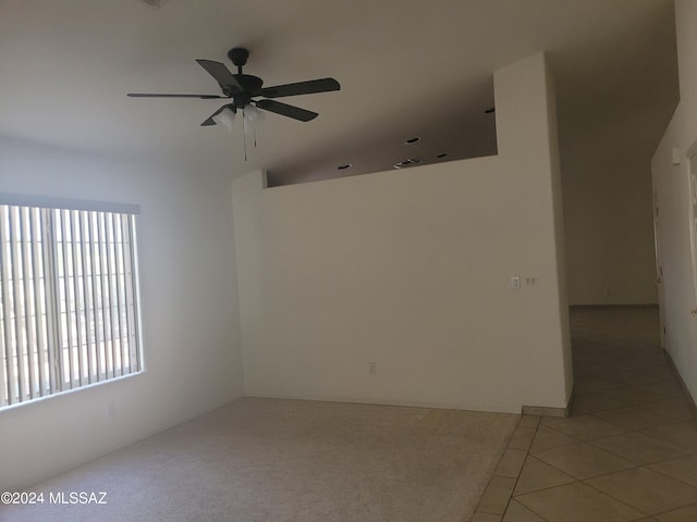 tiled empty room featuring ceiling fan