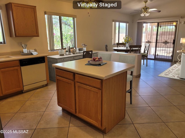 kitchen featuring a center island, white dishwasher, ceiling fan, a healthy amount of sunlight, and light tile patterned flooring