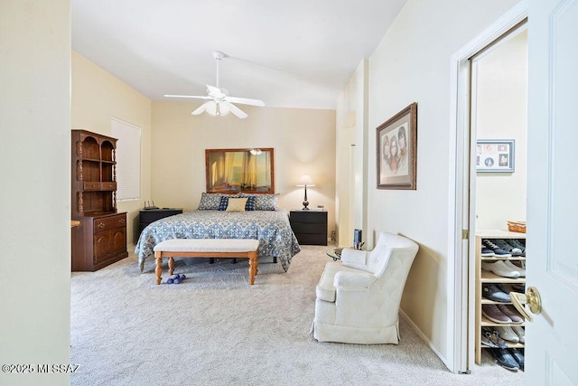 bedroom with multiple windows, light colored carpet, a closet, and ceiling fan