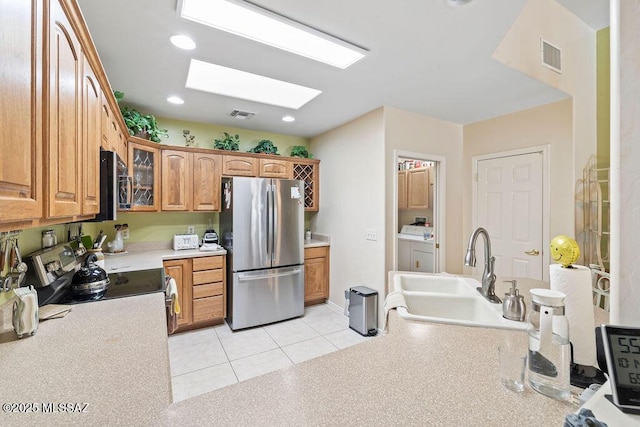 bathroom featuring vanity, a shower with shower door, and tile patterned flooring