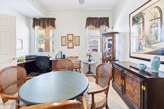 tiled dining area with ceiling fan