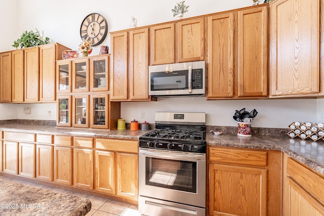 kitchen with stainless steel appliances and light tile patterned floors