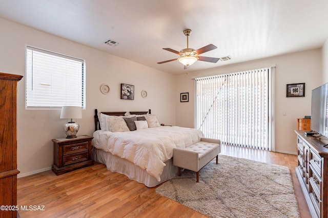 bedroom featuring multiple windows, ceiling fan, access to exterior, and light hardwood / wood-style floors