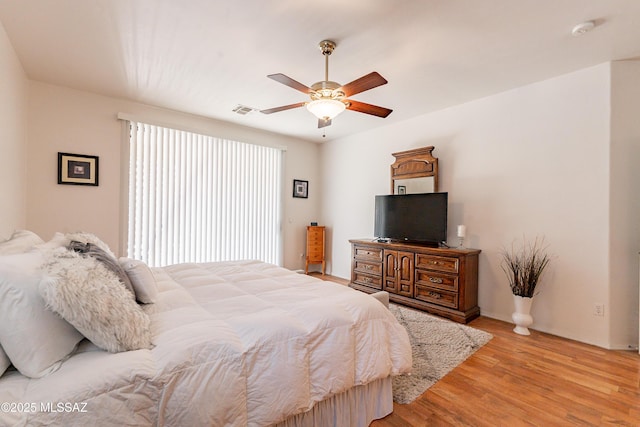 bedroom with ceiling fan and light hardwood / wood-style flooring