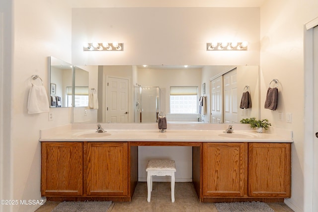 bathroom featuring tile patterned flooring, vanity, and walk in shower