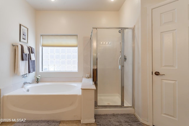 bathroom featuring shower with separate bathtub