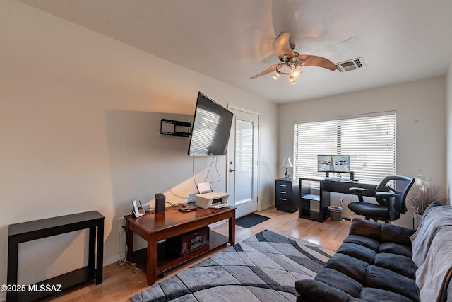 living room with ceiling fan and light wood-type flooring