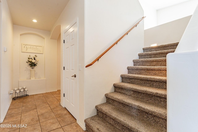 stairway with tile patterned flooring