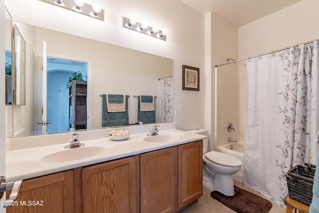 full bathroom with vanity, shower / tub combo with curtain, and toilet