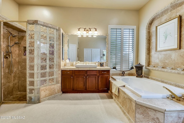 bathroom with walk in shower, vanity, and a bath