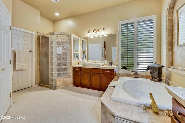 full bath with a garden tub, a shower stall, and vanity