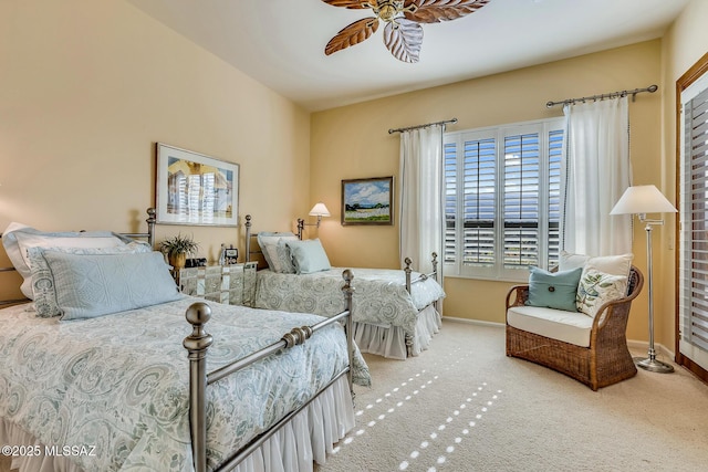 carpeted bedroom with a ceiling fan and baseboards