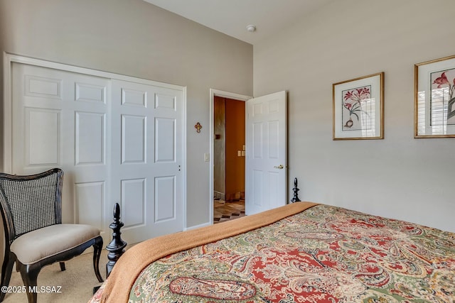 carpeted bedroom featuring vaulted ceiling and a closet