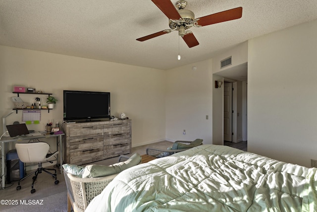 bedroom with a ceiling fan, visible vents, a textured ceiling, and baseboards