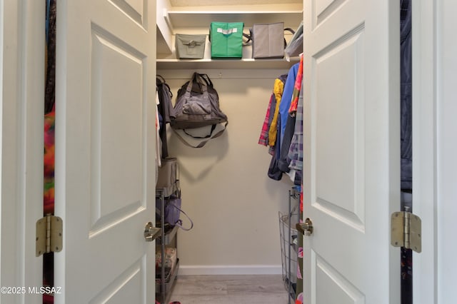 interior space with baseboards and wood finished floors