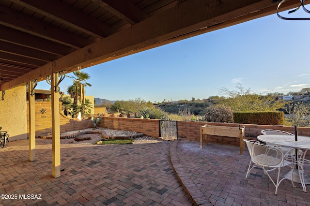 view of patio with outdoor dining space and fence