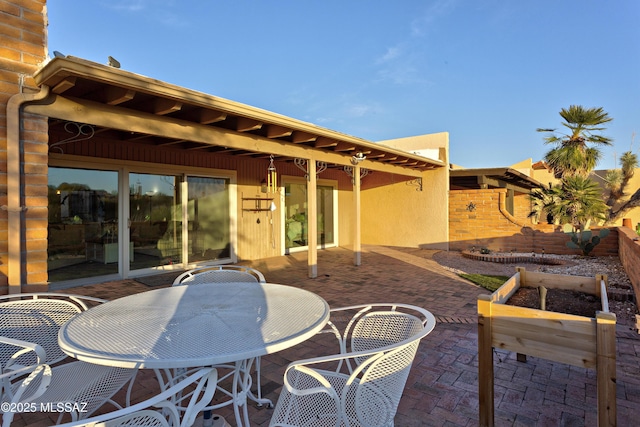 view of patio with outdoor dining space and fence