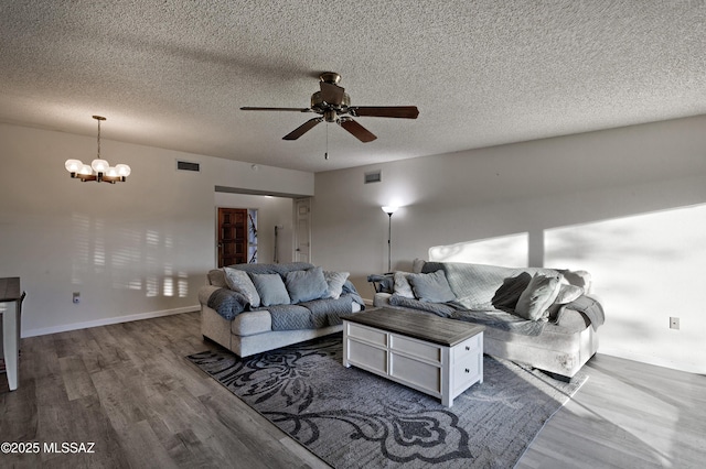 living area with dark wood-style floors, visible vents, and baseboards