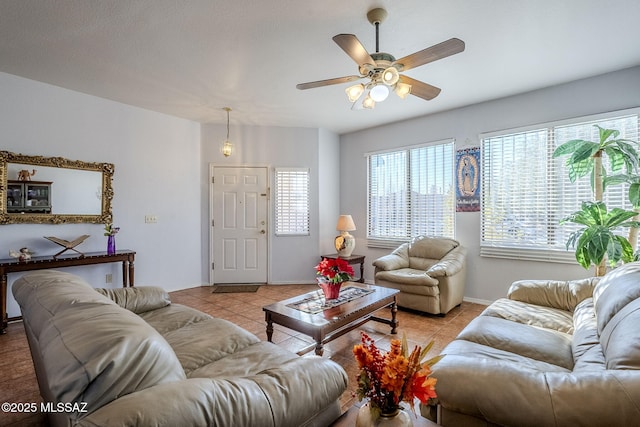 living room with ceiling fan and light tile patterned floors