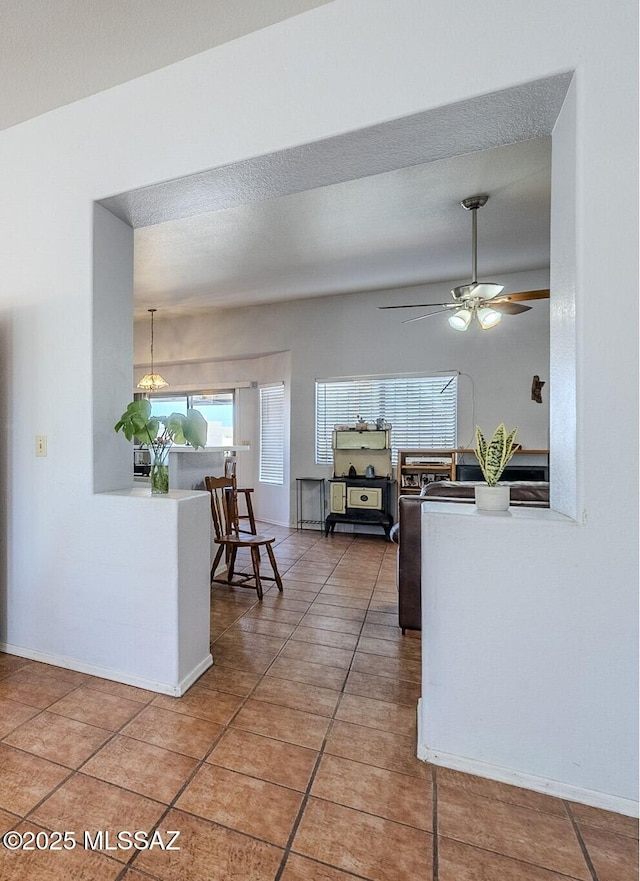 kitchen featuring ceiling fan and tile patterned flooring