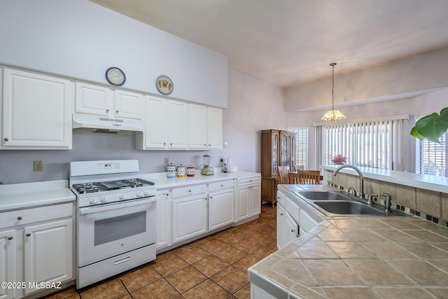 kitchen with an inviting chandelier, white range with gas cooktop, sink, white cabinetry, and decorative light fixtures