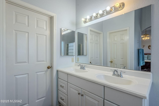 bathroom with ceiling fan and vanity