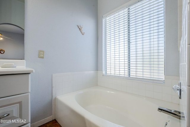 bathroom with a tub and vanity