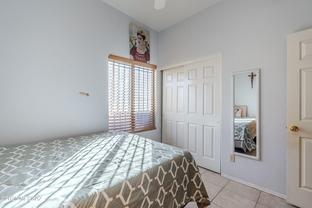 bedroom featuring a closet, ceiling fan, and light tile patterned floors