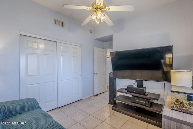 living room featuring ceiling fan and light tile patterned floors