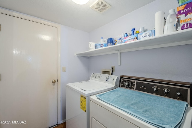 clothes washing area featuring independent washer and dryer