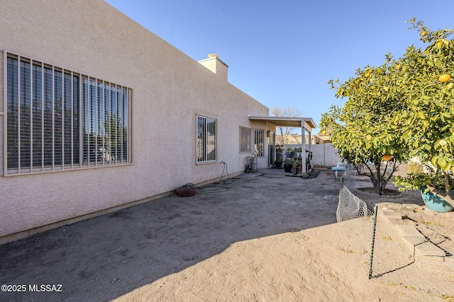 view of side of home featuring a patio area