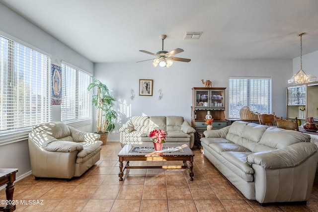 tiled living room with ceiling fan and plenty of natural light