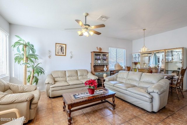 tiled living room featuring ceiling fan