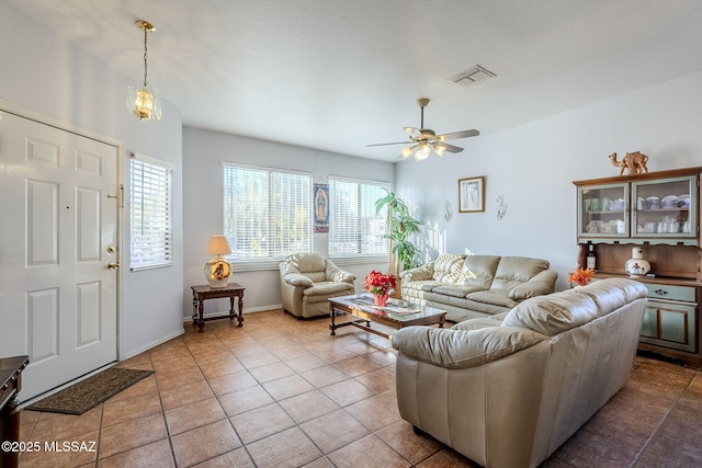 tiled living room with ceiling fan and plenty of natural light