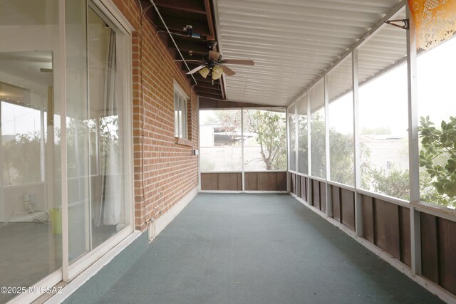 unfurnished sunroom with ceiling fan and a wealth of natural light