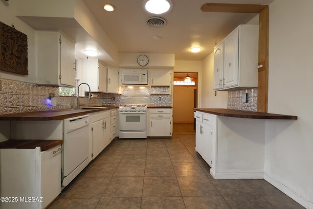 kitchen featuring white appliances, white cabinetry, wood counters, and tasteful backsplash