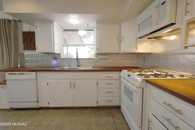 kitchen featuring white appliances, sink, backsplash, and white cabinetry