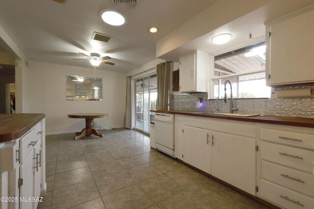 bathroom with toilet, a shower with shower door, decorative backsplash, and sink