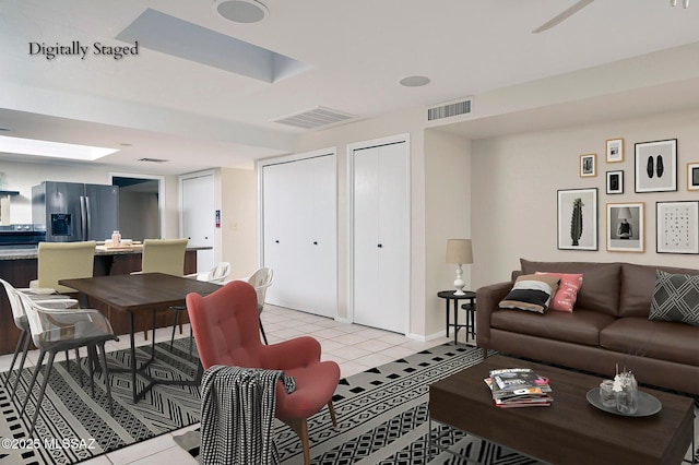 living room featuring visible vents, baseboards, and light tile patterned flooring