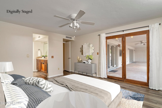 bedroom featuring access to outside, baseboards, ensuite bath, visible vents, and wood finished floors