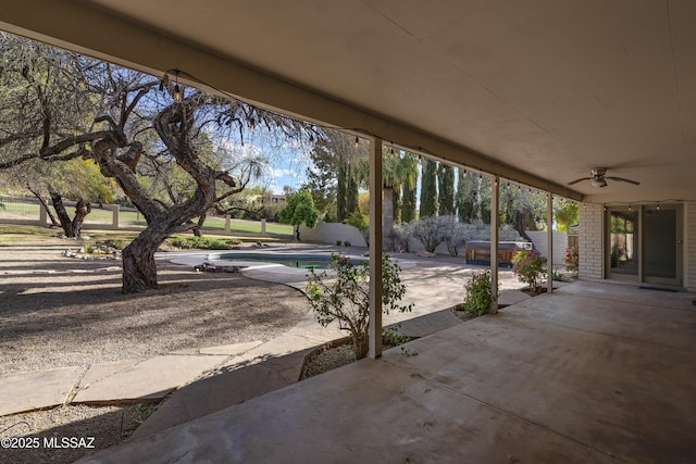 view of patio / terrace with an outdoor pool, a jacuzzi, fence, and a ceiling fan