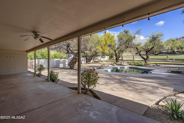 view of patio with a fenced in pool, fence, and ceiling fan