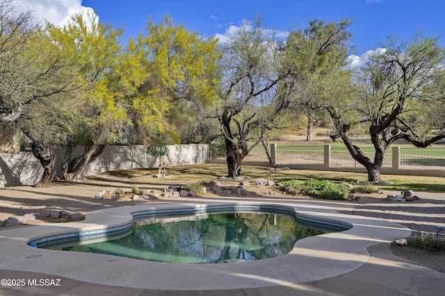 view of pool with a fenced in pool and fence