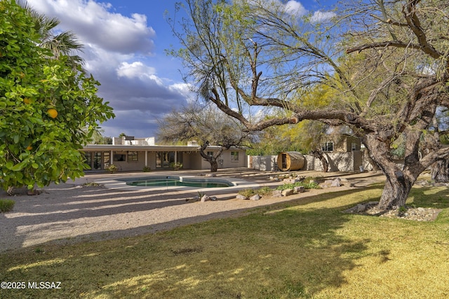 surrounding community with a patio, a swimming pool, fence, and a lawn
