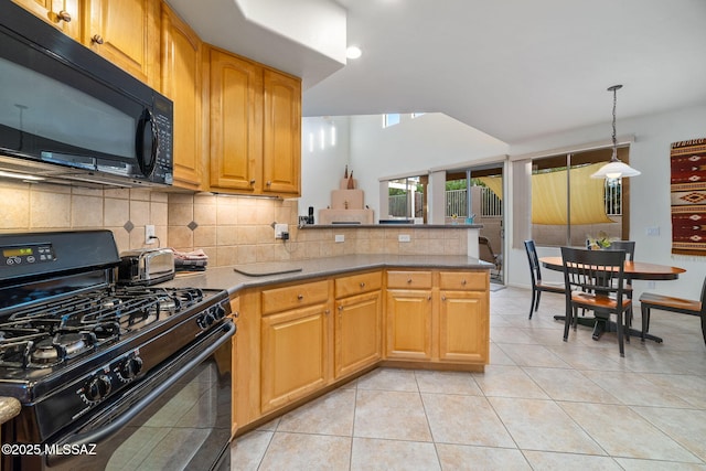 kitchen featuring lofted ceiling, light tile patterned floors, hanging light fixtures, black appliances, and decorative backsplash