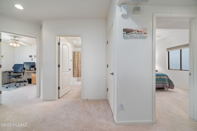 corridor featuring light colored carpet